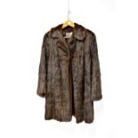 A mink three-quarter length fur coat, with silk lining and label inscribed 'Browns of Chester',
