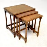 A nest of three oak rectangular occasional tables raised on ring turned and block supports.