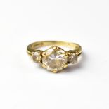 A 9ct gold dress ring set with large clear stone, with smaller white stone either side,