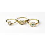 Three 9ct gold dress rings comprising a modern example with flower-shaped top and central green