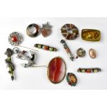 Fourteen late 19th and early 20th century Scottish-themed and polished agate brooches,