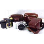 Four modern and vintage cameras comprising a Sony Alpha 5000 digital camera with lens,