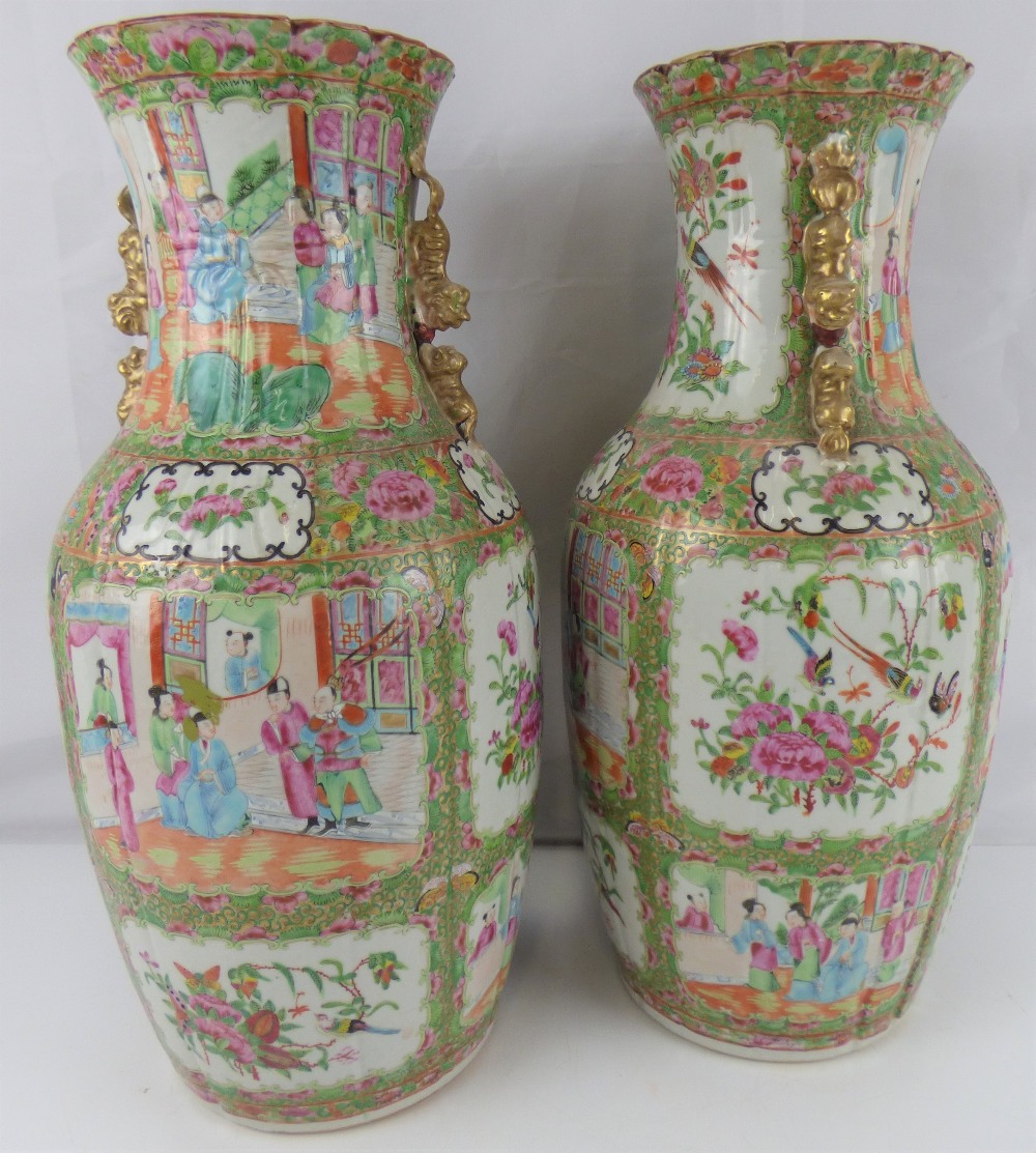 A pair of late 19th century Canton Famille Rose vases with all-over decoration, unmarked,