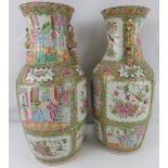 A pair of late 19th century Canton Famille Rose vases with all-over decoration, unmarked,