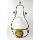 A French brass hanging oil lamp with opaque white shade and clear glass funnel,