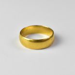 An 18ct gold large band ring, size W, approx 7.2g.