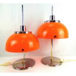HARVEY GUZZINI; a pair of 1970s Faro lamps, with orange acrylic shades,