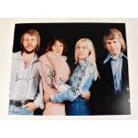 ABBA; colour promotional photograph bearing signatures of all four members of the band.