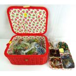 An embroidered and woven carry jewellery case containing various modern and vintage costume