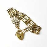 A 9ct gold five bar gate bracelet, with heart-shaped padlock clasp stamped '375', approx 11.1g.