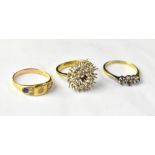 Three 18ct gold rings, each with faults, comprising a cluster ring (lacking all stones), size L,