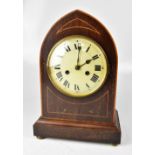 An Edwardian mahogany and boxwood strung lancet-topped mantel clock,