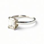 A good palladium and diamond solitaire ring, the emerald cut four-claw set stone weighing approx 2.