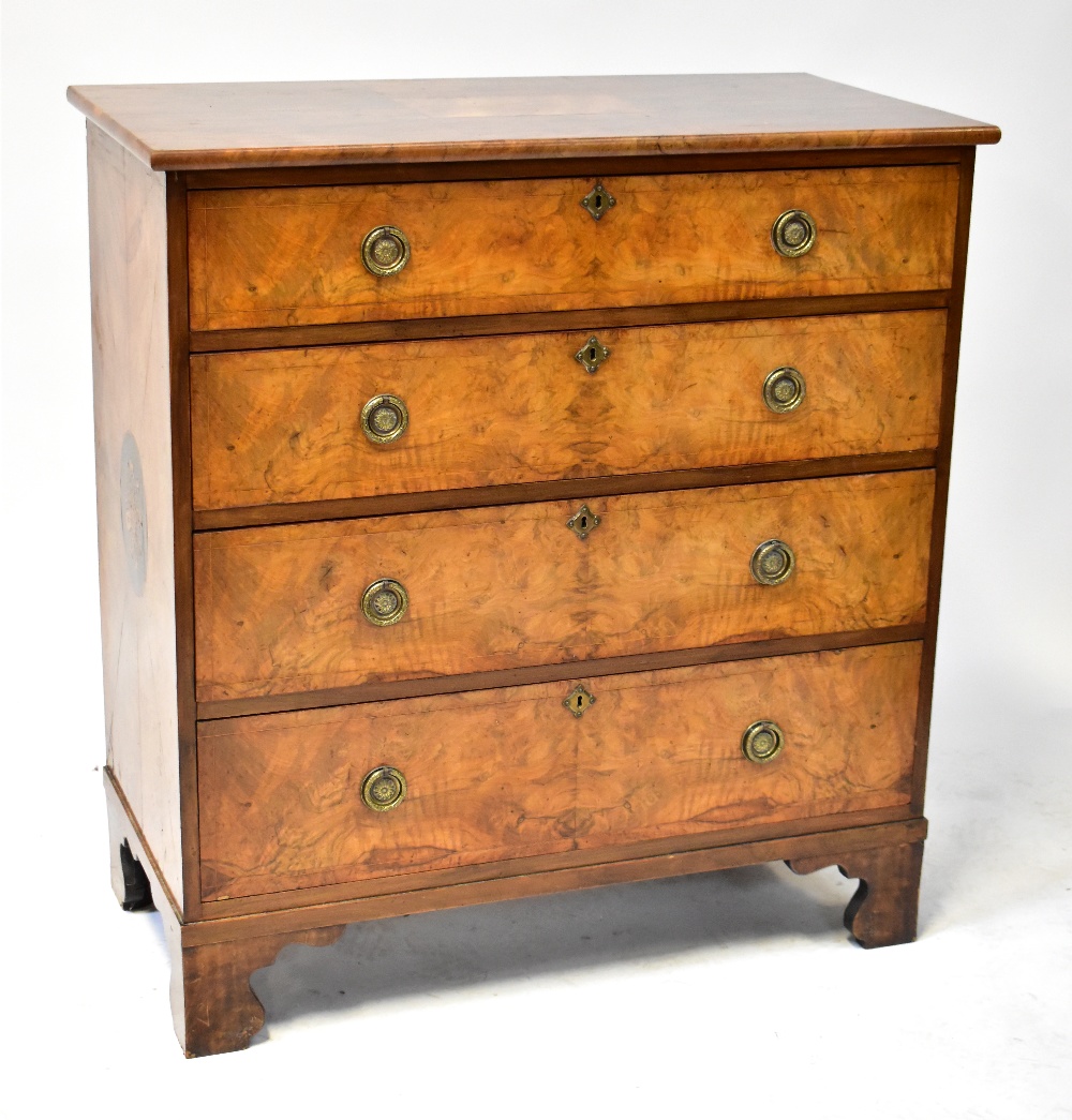 A 19th century walnut chest of four long graduated drawers, raised on bracket feet,