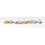 Eight fashion rings set with gemstones, each with a retail tag describing the stone (8).