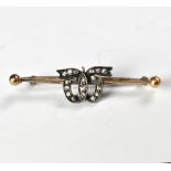 A Victorian bar brooch with central bow clad with tiny old cut diamonds, length approx 4.