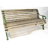 A vintage green painted garden bench with scrolling ends and teak slats, 76 x 152 x 72cm.