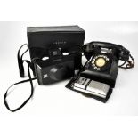 A vintage black pyramid telephone, a cased Polaroid EE100 camera,
