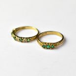 Two 9ct gold green stone dress rings, one with three green stones in an oval mount, size P,