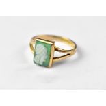 A 9ct gold cameo ring, the tablet-shaped green stone cameo with a carved Greek head,