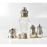 A cut glass sifter with hallmarked silver top, a hallmarked silver cruet set comprising salt,