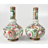A pair of Chinese late 19th century Famille Rose bottle neck vases, unmarked, heights 14.5cm (2).