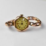 A ladies' vintage 9ct gold head wristwatch, the white dial set with Arabic numerals and red 12,