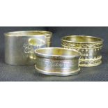 Three hallmarked silver napkin rings of different designs,