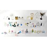 A collection of miniature glass ornaments to include Swarovski and similar animals, a glass train,