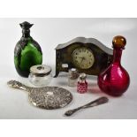 An Arts & Crafts brass mantel clock, the dial set with Arabic numerals,