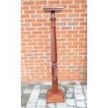 A large mahogany plant stand with stepped square top,