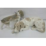 LLADRÓ; two large porcelain figures of dogs comprising a resting hound,