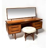 G PLAN; a 1960s teak mirror backed dressing table, 71 x 152 x 46cm,