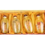 A cased presentation set of four early 20th century miniature perfume bottles,