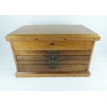 A vintage oak toolmaker's chest with lift-up storage section,