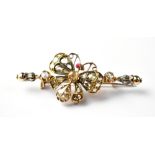 A yellow metal rope twist bar brooch with central butterfly set with rose cut diamonds and red