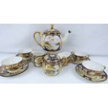 NORITAKE; an early 20th century fifteen-piece tea service with hand painted rural landscape panels,