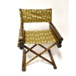 An Oriental bamboo folding armchair with material seat and back rest, height 96cm.