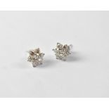 A pair of white gold floral set diamond stud earrings, the central stone approx 0.