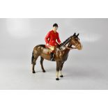 BESWICK; a model of a huntsman on horseback, 17.5 x 22cm.
