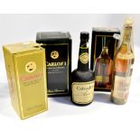 Five boxed and unboxed bottles of brandy comprising a boxed Carlosi Grand Reserve,