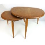 ERCOL; two vintage pebble-style coffee tables with three tapered turned legs,