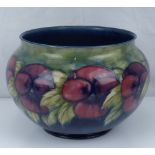 WILLIAM MOORCROFT; a large pottery jardinière decorated with repeating pansies and leaf pattern,