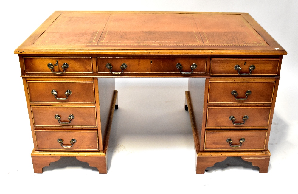 A Georgian-style mahogany desk with tool