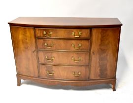A Reprodux Georgian-style mahogany bow-fronted sideboard with pair of doors flanking four drawers,