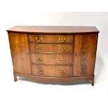 A Reprodux Georgian-style mahogany bow-fronted sideboard with pair of doors flanking four drawers,