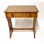An oak single-drawer side table with Gothic-style supports united by a stretcher, 84 x 76 x 45cm.