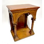 A Victorian oak ecclesiastical side table with a replaced top above Gothic columns, to plinth base,