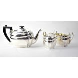 A George V hallmarked silver three-piece tea set of oval form,