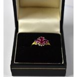 An 18ct yellow gold diamond and ruby cluster ring of marquise form, size J, approx 4.15g.